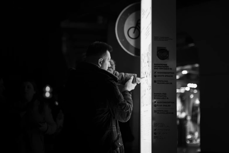 a man is taking a picture of a sign post