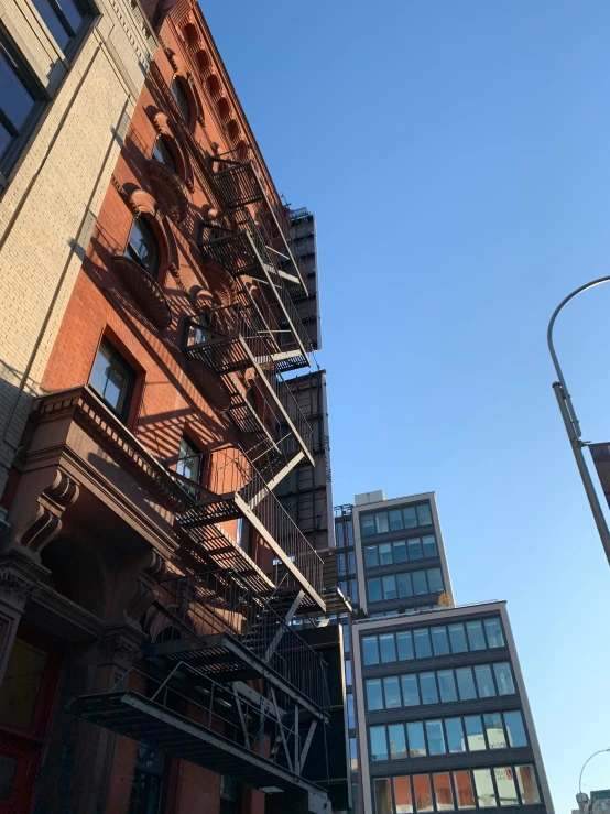 a city street corner with various buildings and a bunch of stairs