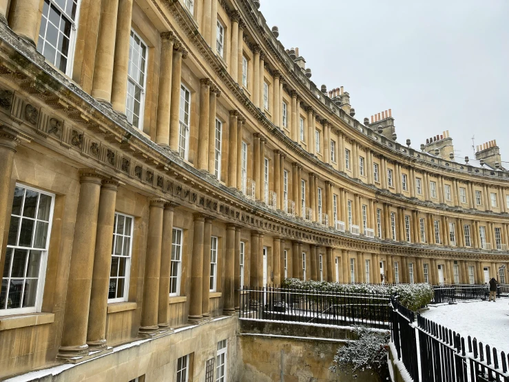 a large building that is surrounded by snow