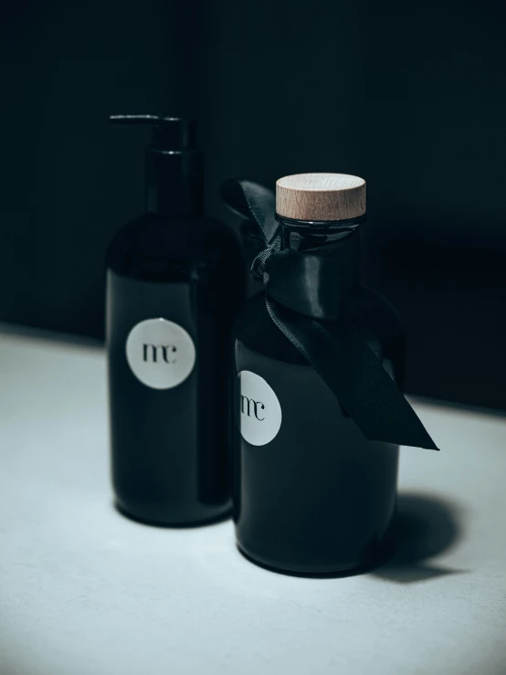 two black bottles sitting next to each other