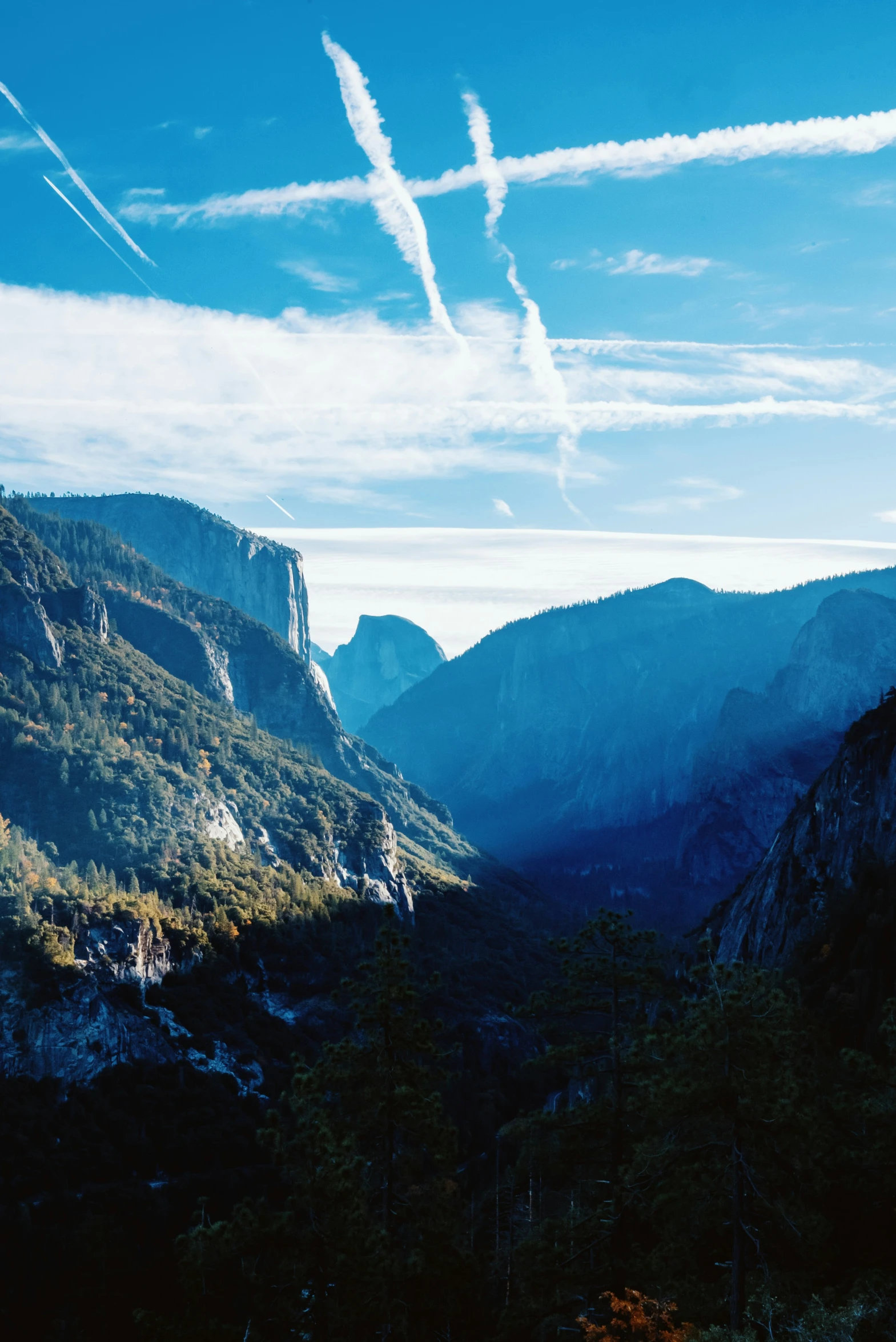 there are some contrails over the mountains