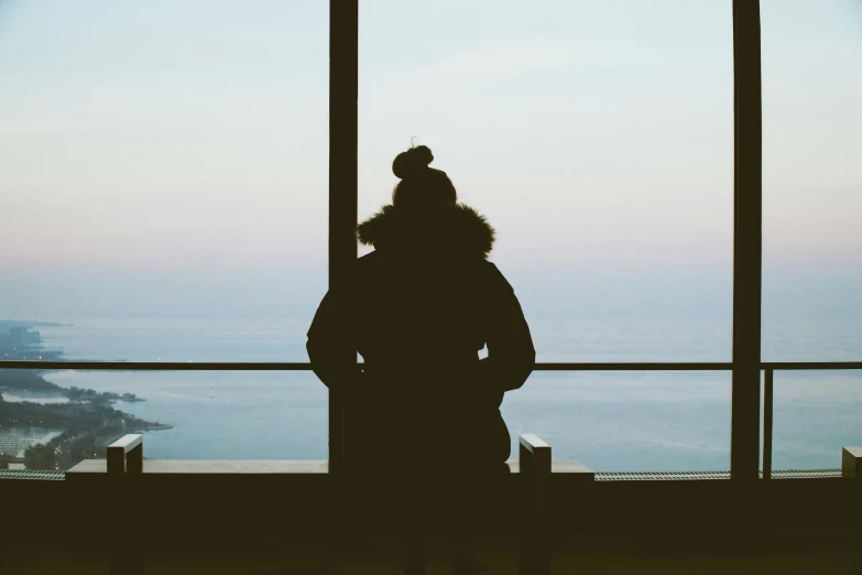 a person is looking out an airport window