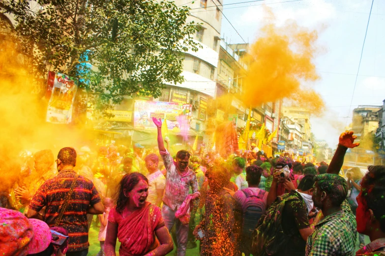 people celeting at a colored festival in the street