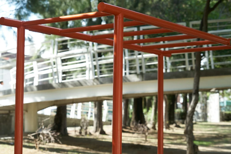 an orange frame with the side section of a structure with a stairway behind it