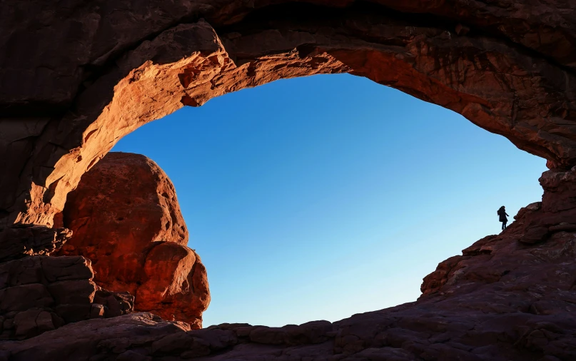 an open cave with a man standing on it