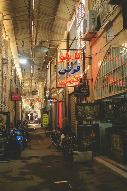 a narrow alley with many bicycles parked