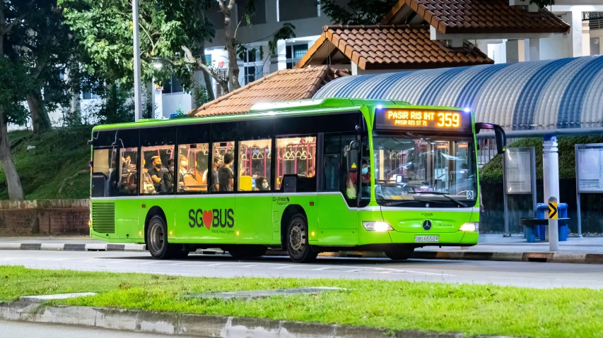 a city bus is pulled up at the stop