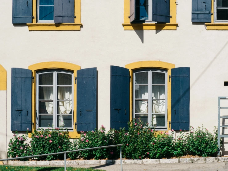 a white house with blue shutters and windows