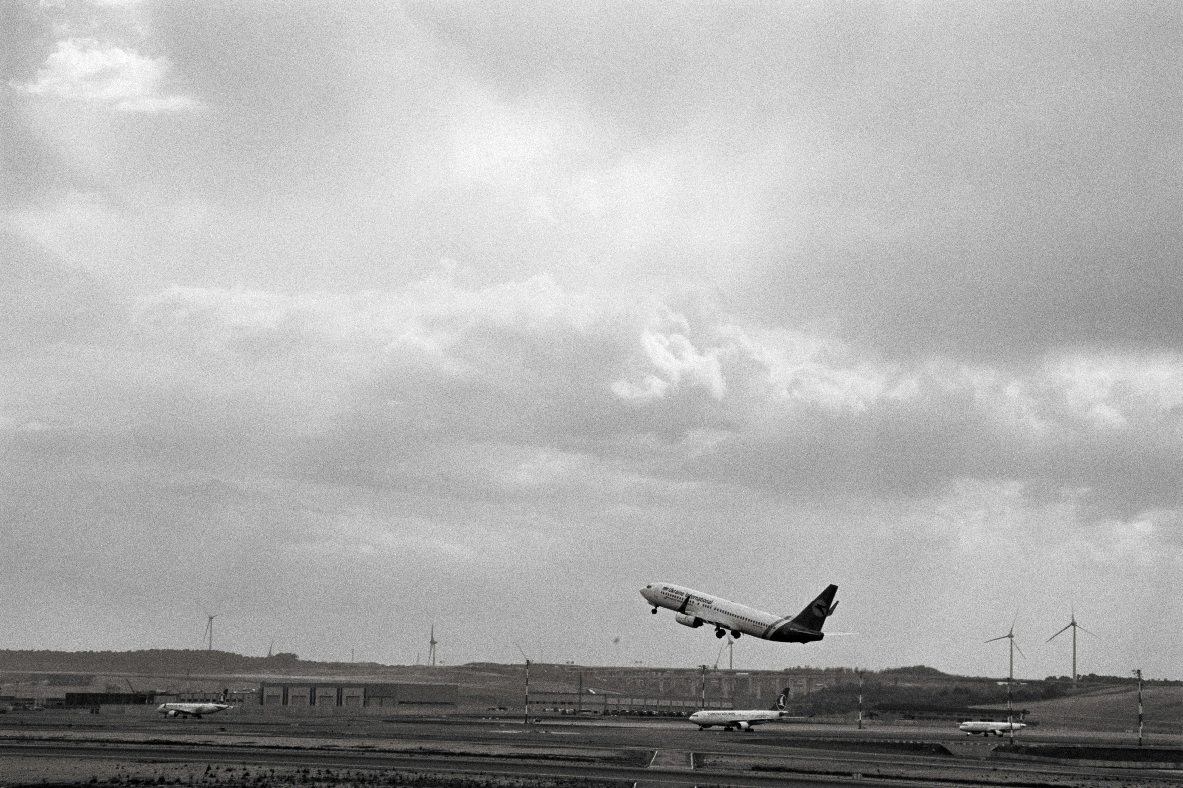 a black and white po of an airplane taking off