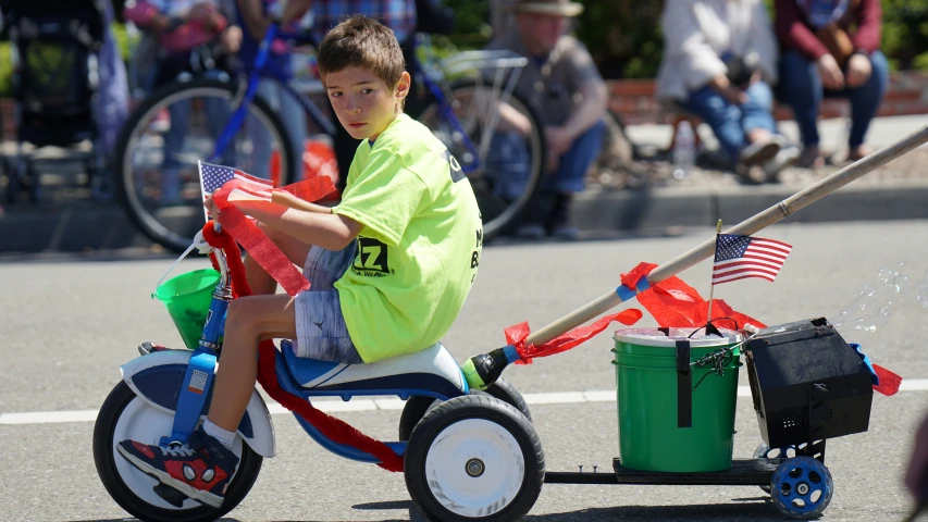  riding a tricycle with american flags