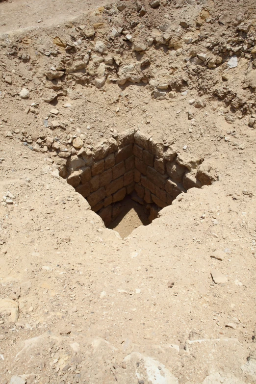 a partially open fire hydrant hole in the ground