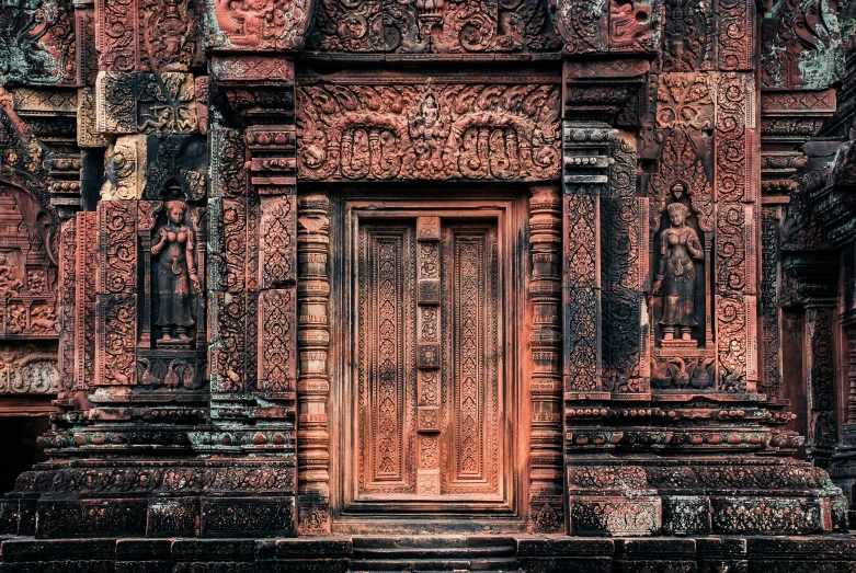 a large doorway with carvings on it in a very old building