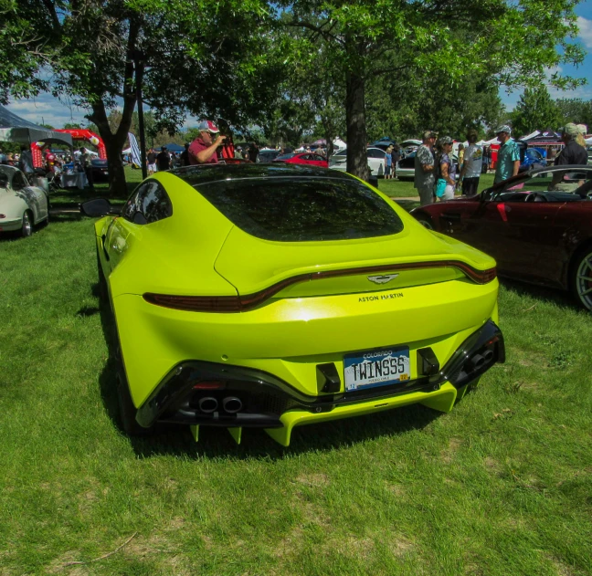 two colorful sports cars are on display at an event