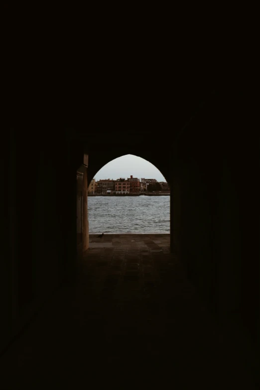 a window is open to show a lake and buildings