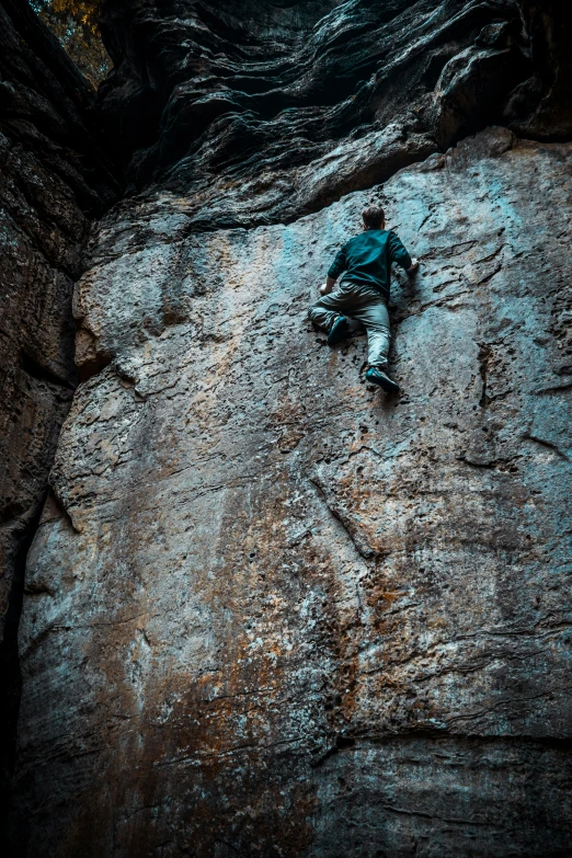 a person is sitting on the rock face