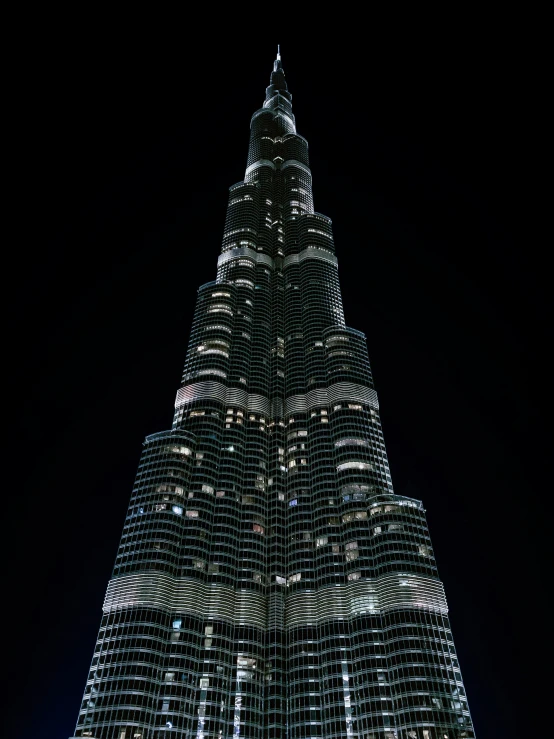 the view from below of the burj tower at night