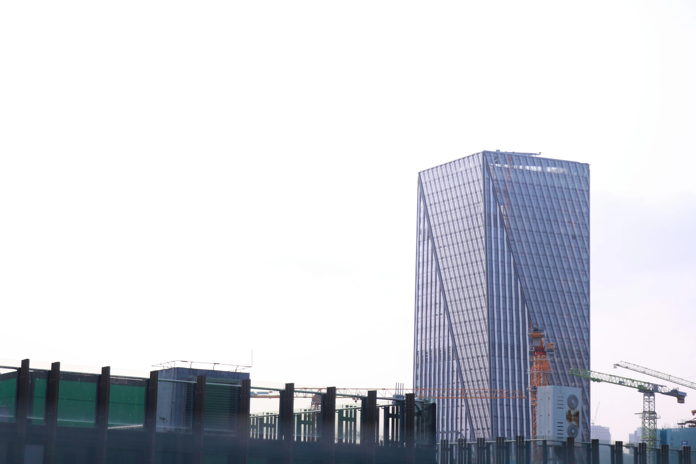 a tall building sitting next to a train yard