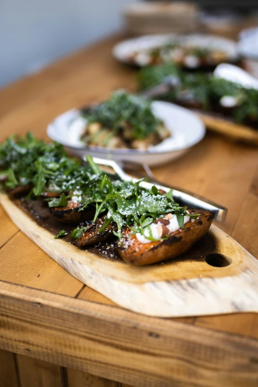 the food is on a wooden plate on a dining table