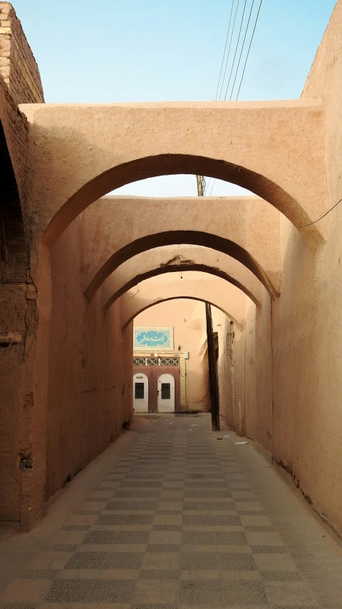 some concrete buildings with a tiled floor and a brick pathway