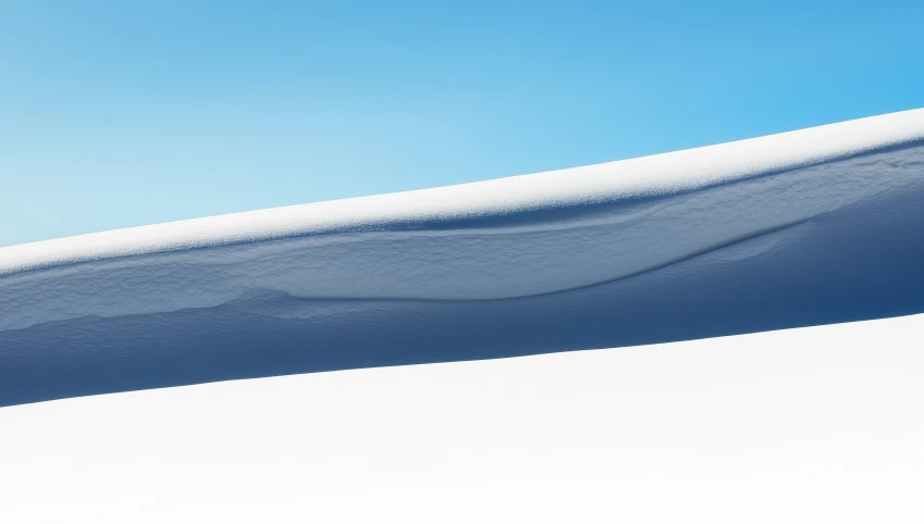 a snow skier in white is skiing down the slope