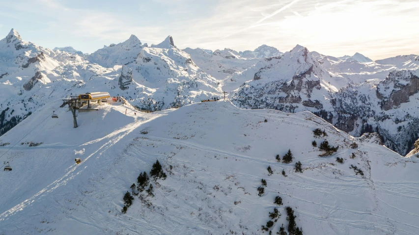 a snowy mountain side, with some snow covered mountains