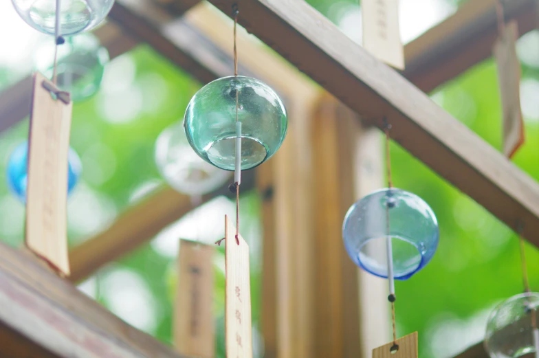 some glass items hanging from a wooden frame