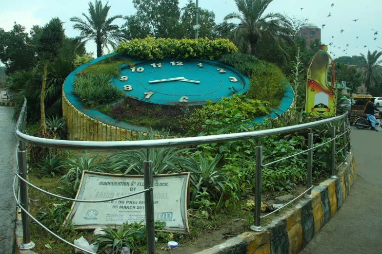 there is an artistic garden clock on display