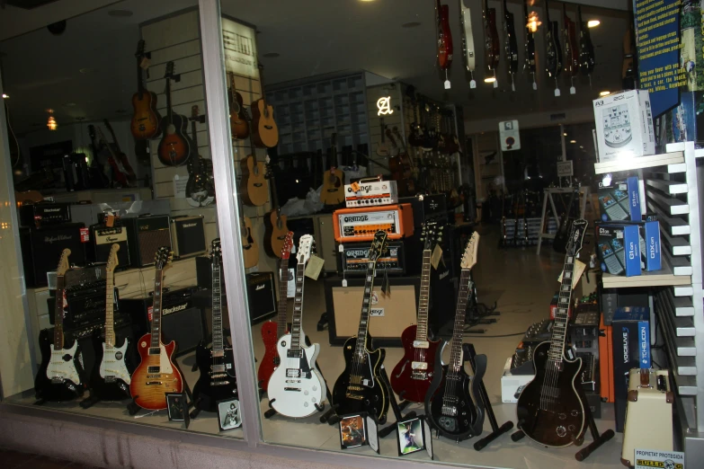 some guitars sitting in a window in a store