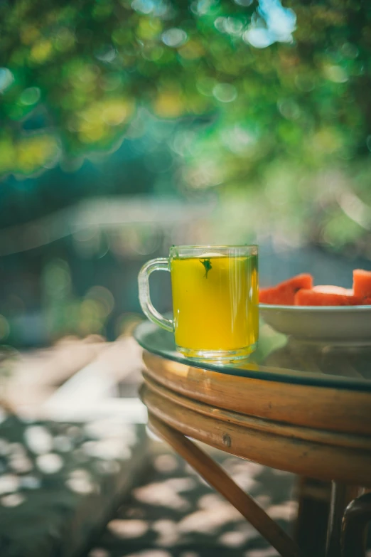 a glass coffee cup filled with liquid near food