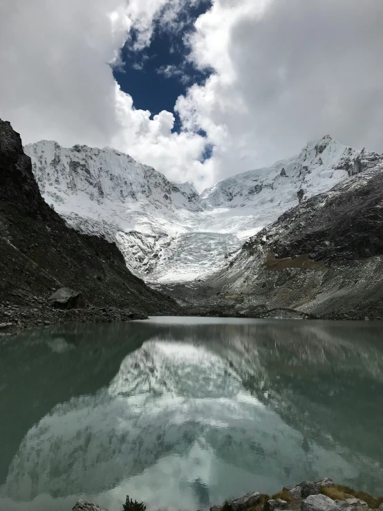 an image of snow covered mountains by the water