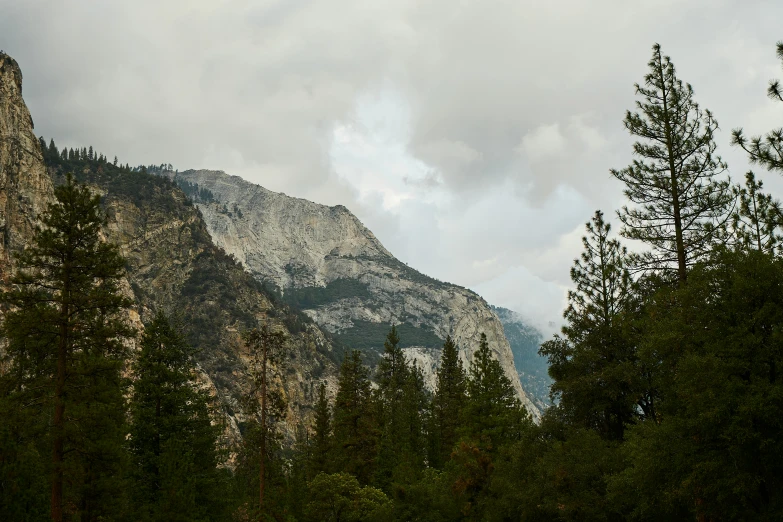 there is a picture of a mountainside with clouds in the sky