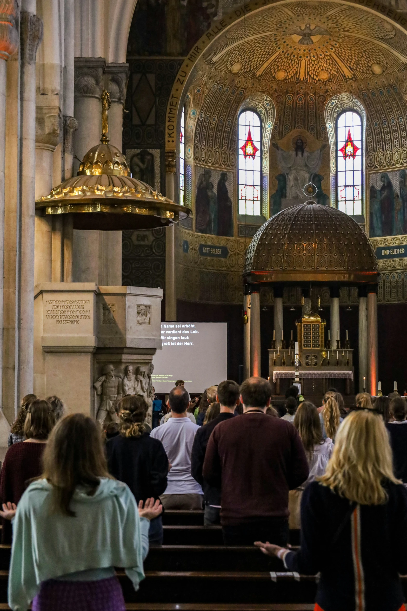 many people are gathered in a church to perform a service