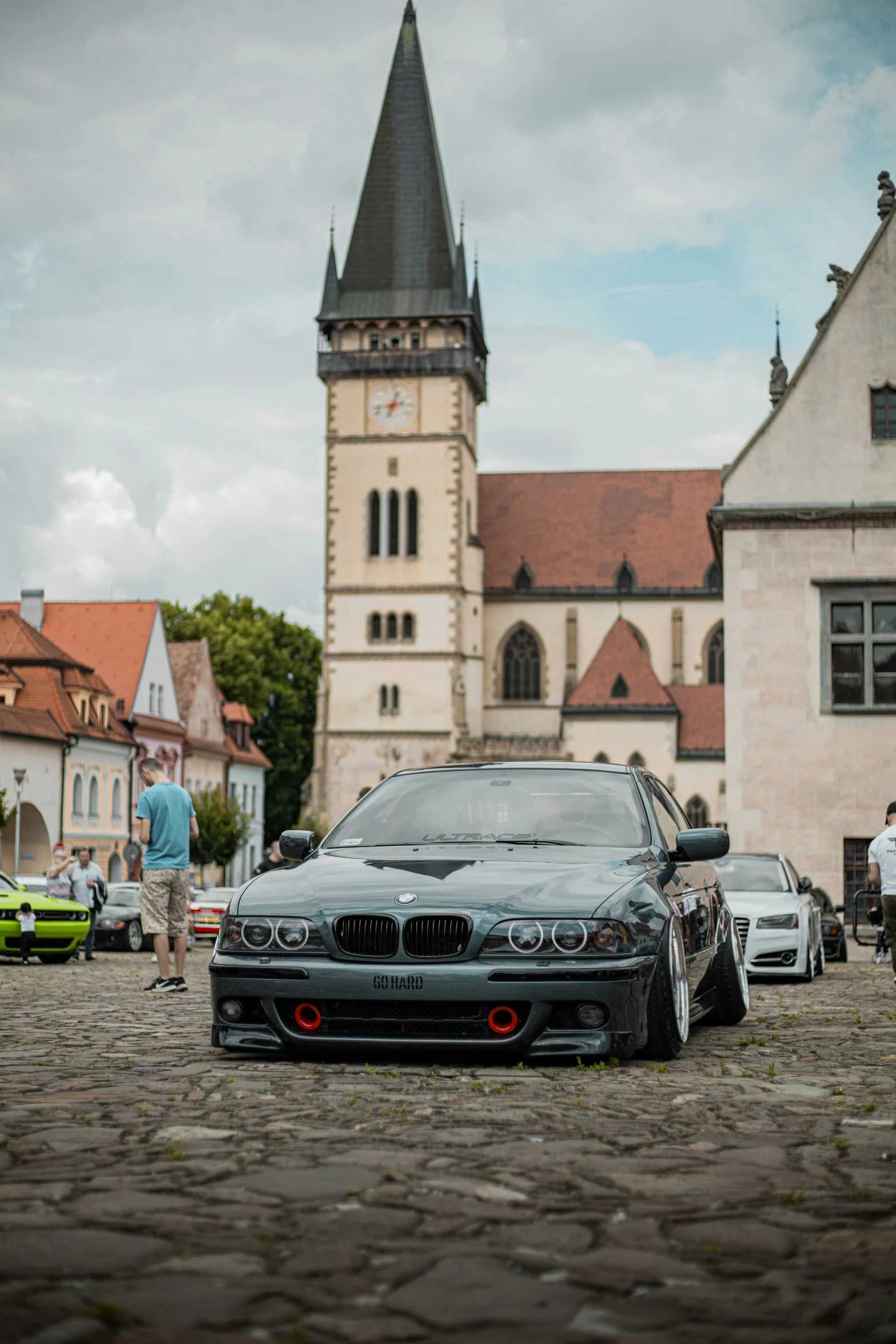 two cars parked in front of a very old building