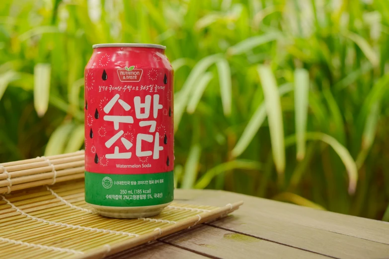 a can of sake beer sitting on a bamboo mat