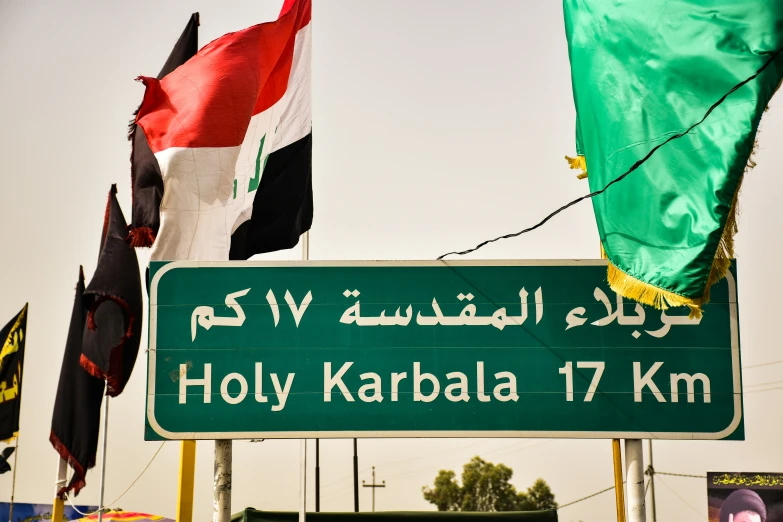 street sign with a variety of flags in the background
