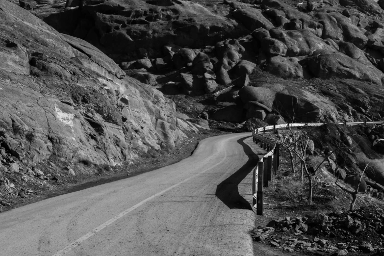 there is a road going through a rocky valley