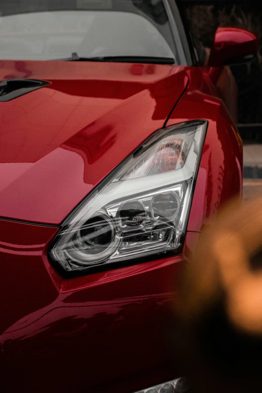 the hood and grill on a car in front of a blurry street