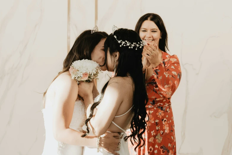 two girls are hugging and posing for a picture