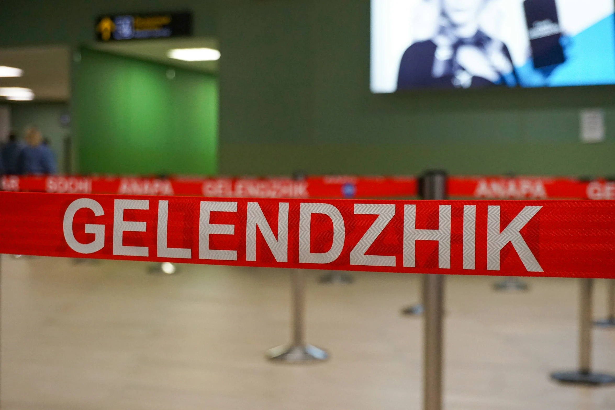a sign is placed in the airport with a red bar