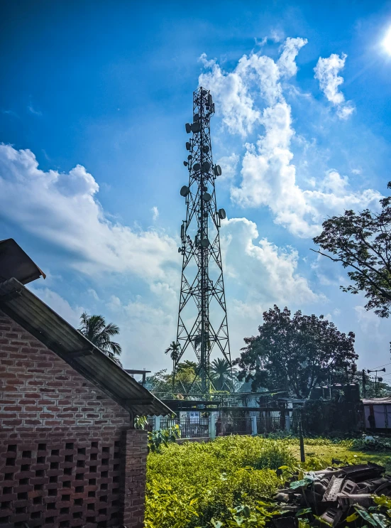 the top of a tower against a partly cloudy sky