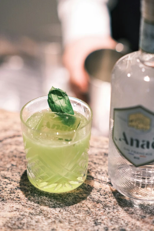 a bottle of alcohol and a glass sitting on a table