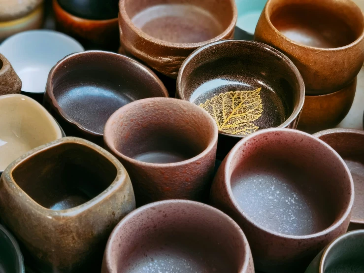 lots of bowls sitting on top of a white table