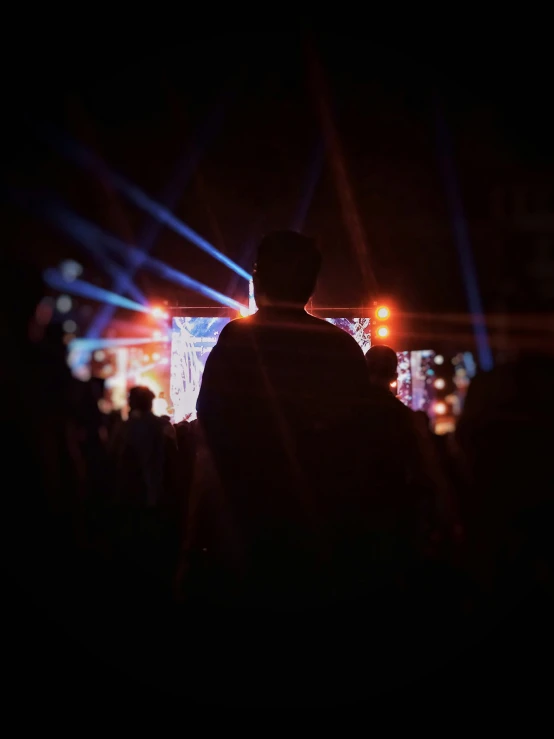 silhouette of man with light at night in city