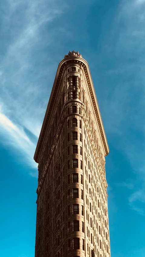 a tall brown building with windows on top