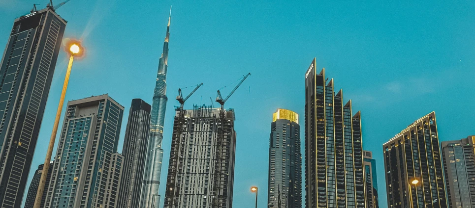 buildings under construction in a city at dusk