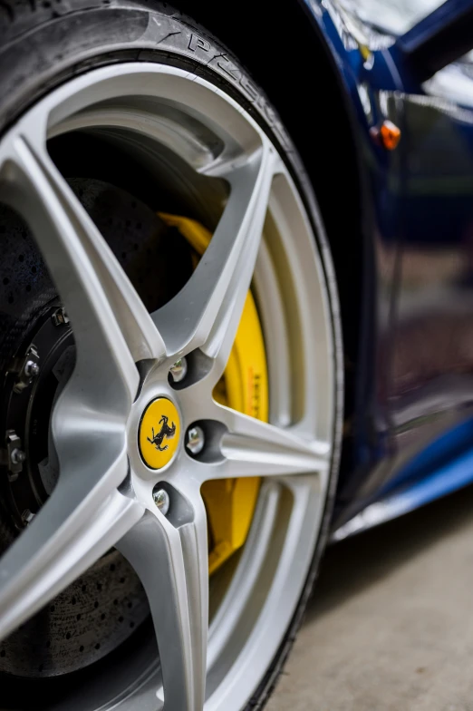 a blue and yellow sports car that's being driven