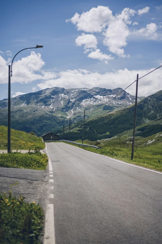 there is an empty street in the mountains