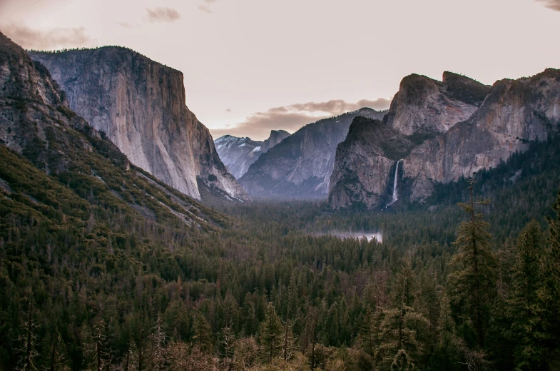 a very scenic view of mountains, valleys and forest