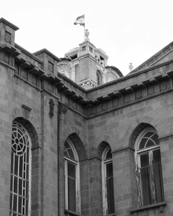 a black and white po of an old building with three windows