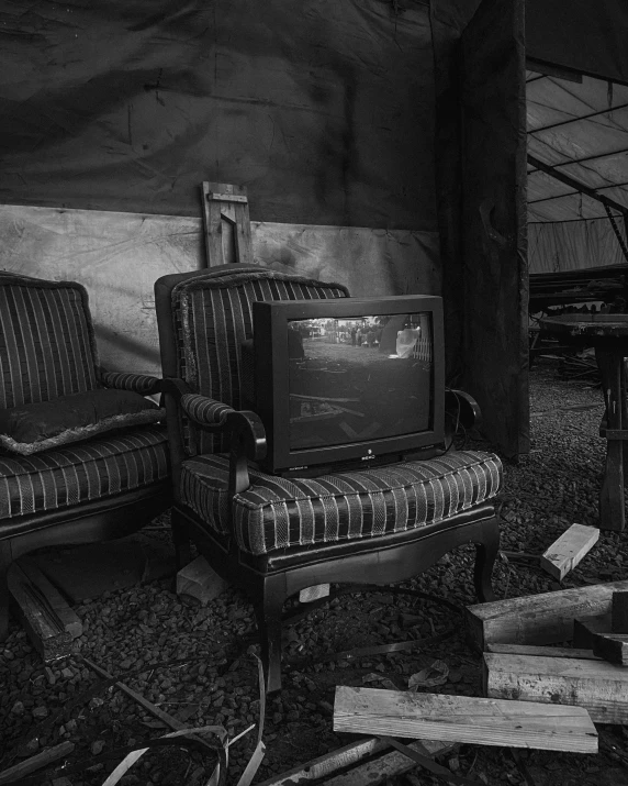 an old tv sitting next to a couch in a room